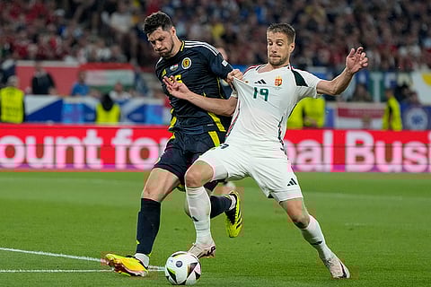 Scott McKenna and Barnabas Varga challenge for the ball